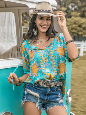 Woman in printed tie neck half sleeve blouse by a vintage van