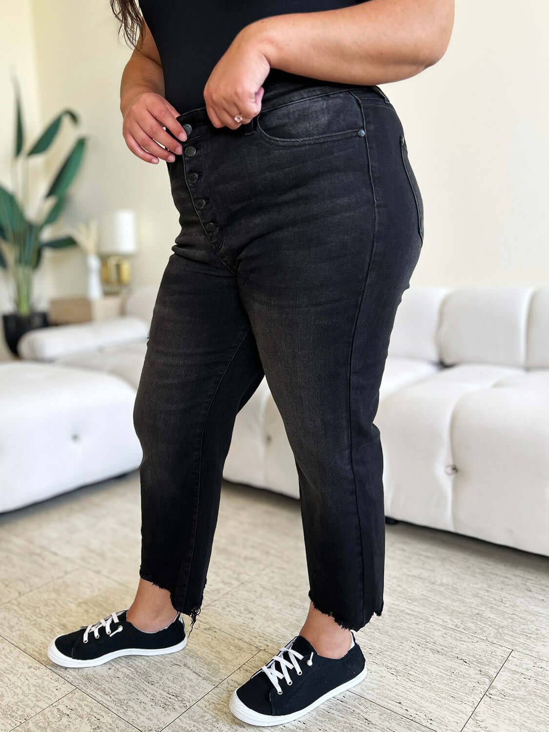 a woman standing in a living room with her hands on her hips