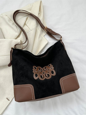 Ochre suede patch tote bag with adjustable strap and brown accents.