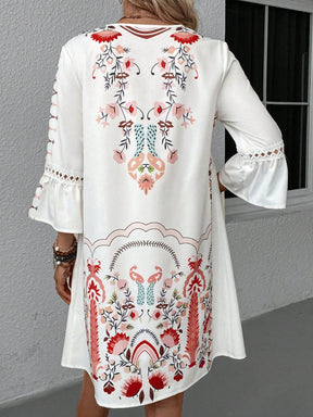 White dress with intricate back print and lace sleeves