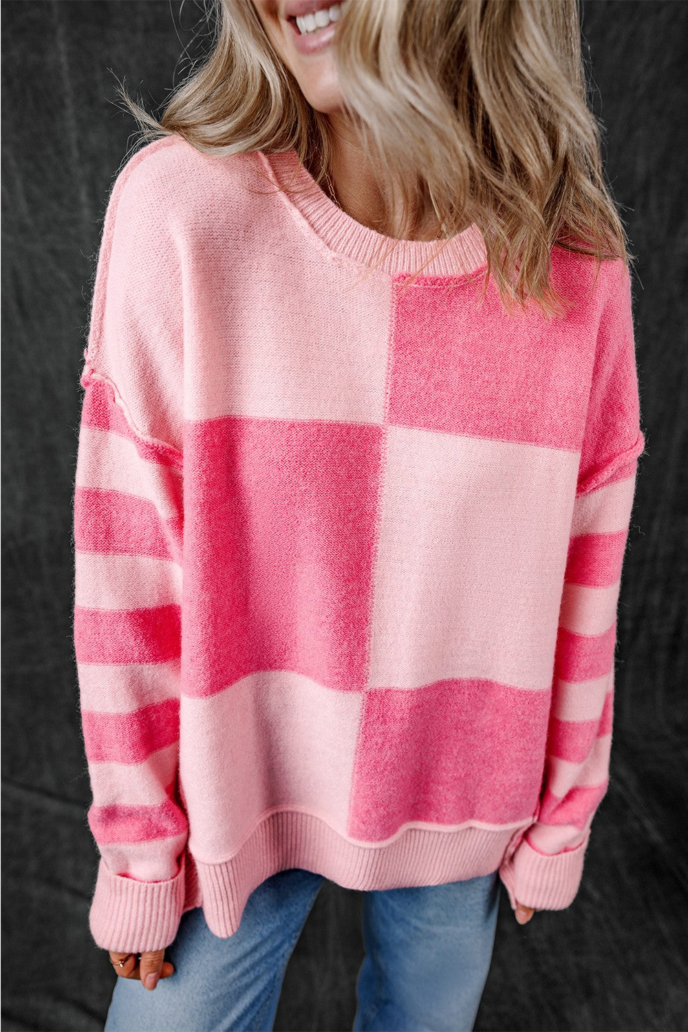 Pink exposed seam round neck sweater, front view