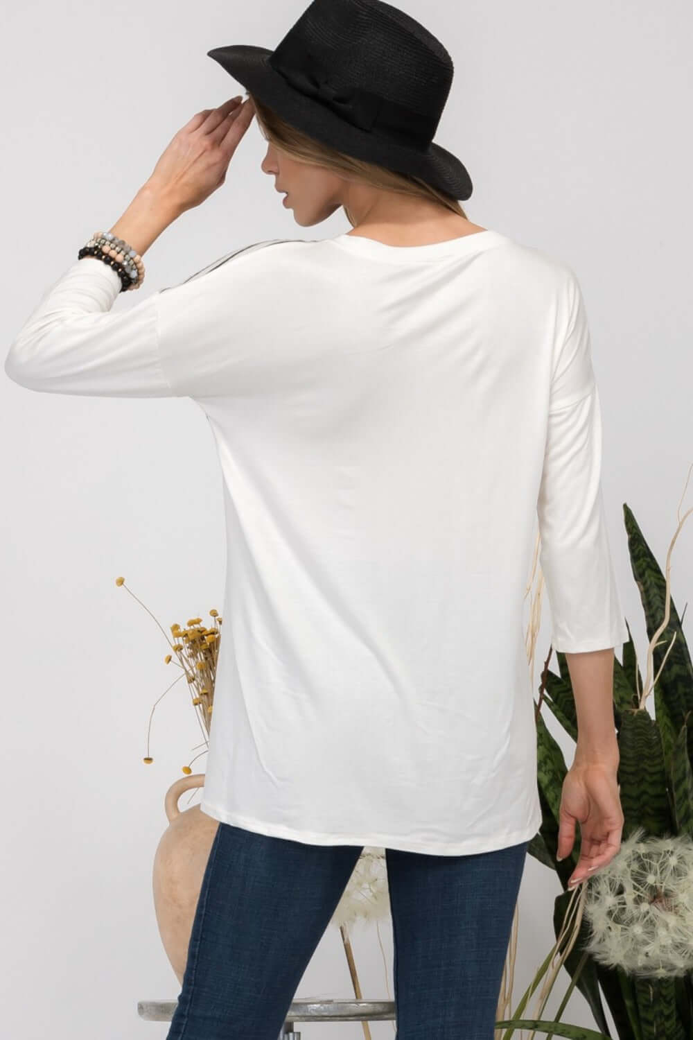 Back view of white V-neck T-shirt with long sleeves