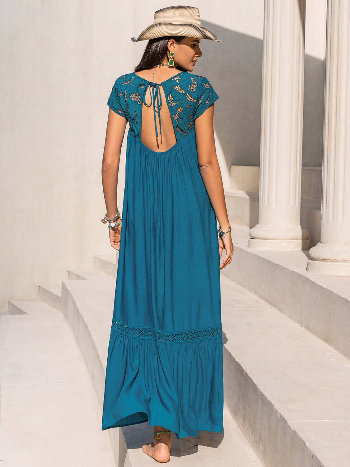 Back view of teal backless maxi dress with tied lace detail