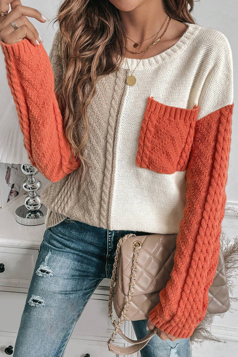 Orange and cream color block round neck sweater