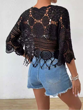 Back view of black openwork cover-up with fringe