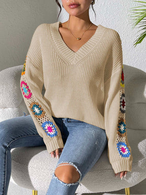 Beige crochet flower V-neck sweater with colorful sleeve details.