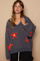 a woman wearing a sweater with stars on it