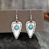 Alloy turquoise heart dangle earrings on display