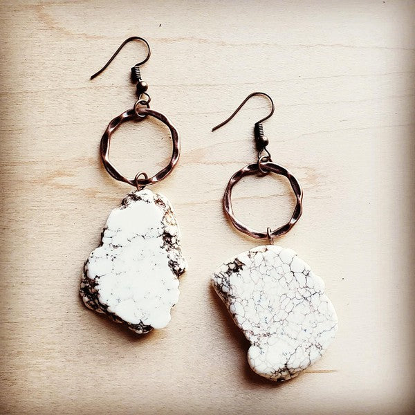 a pair of white and black stone earrings