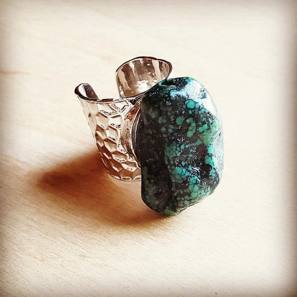 a ring with a stone on it sitting on a table