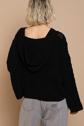 Back view of black twisted knit sweater with hood