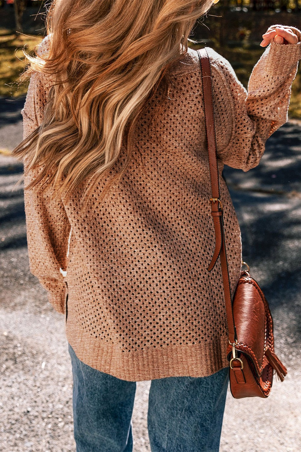 Back view of beige openwork V-neck sweater