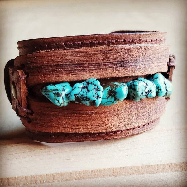 a leather belt with turquoise stones on it