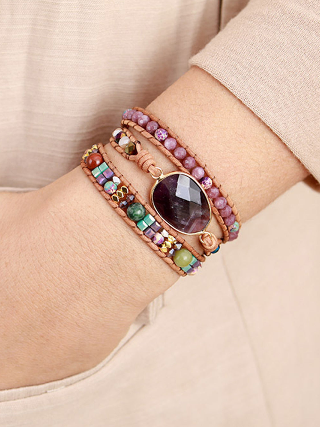 Triple-layer amethyst bracelet on wrist