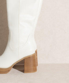 Close-up of white platform knee-high boots heel