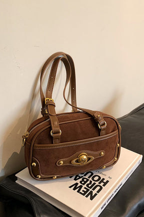 Dark brown suede shoulder bag with studs and adjustable strap