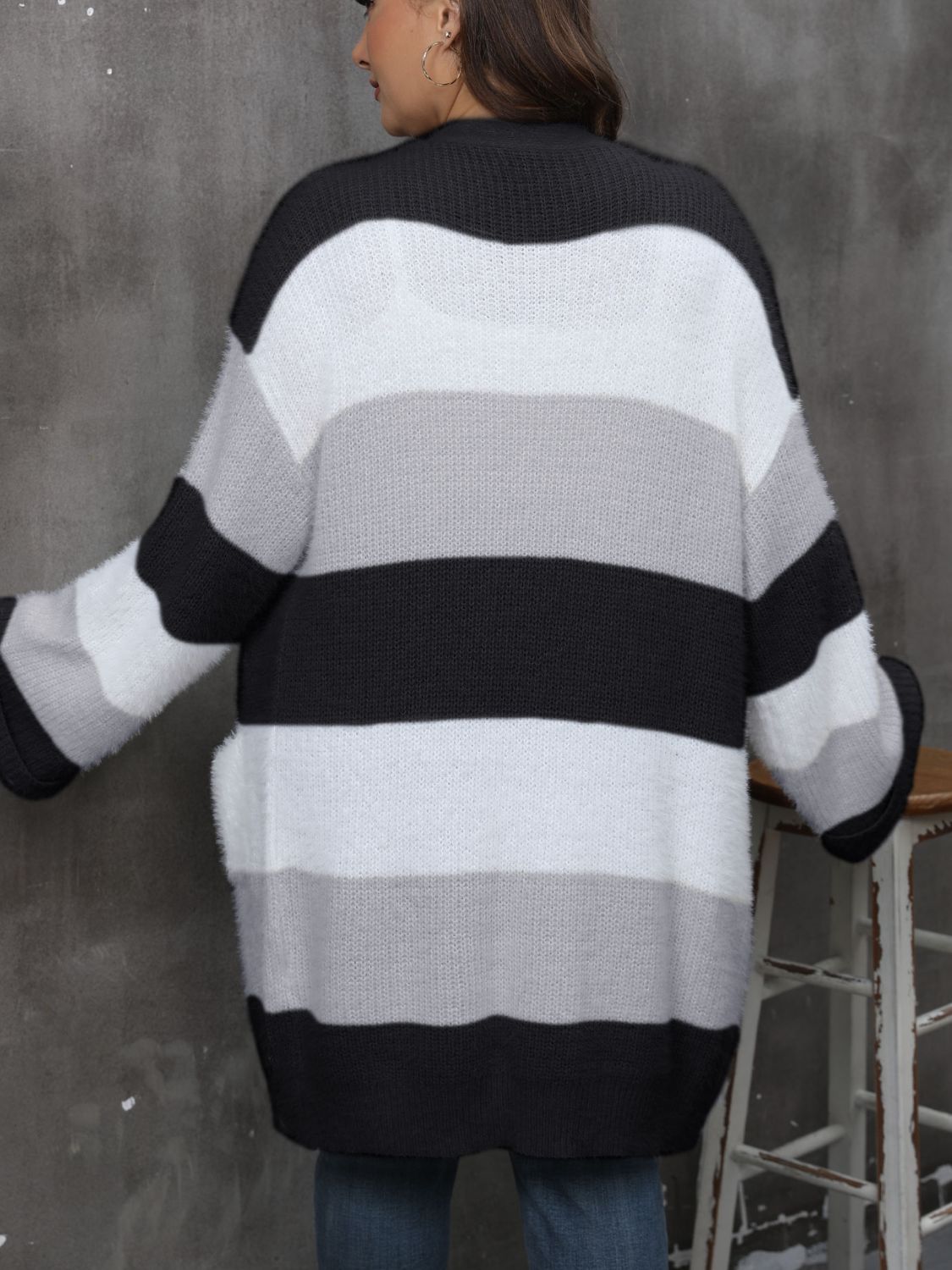 a woman wearing a black and white striped sweater