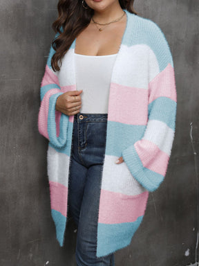 a woman wearing a pink, blue and white striped cardigan