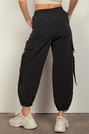 Back view of black woven cargo pants with elastic waist