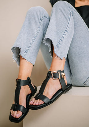 Close-up of black AVA 2 flat sandals with buckle detail.