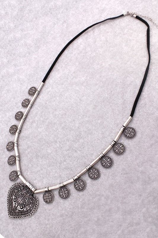 Bohemian necklace featuring intricate silver design and heart pendant