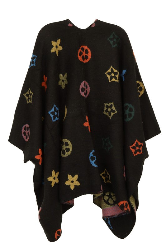 Black poncho featuring multi color geometric motifs