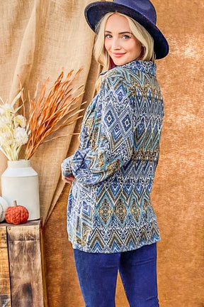 Side view of blue print twist knot long sleeve blouse.