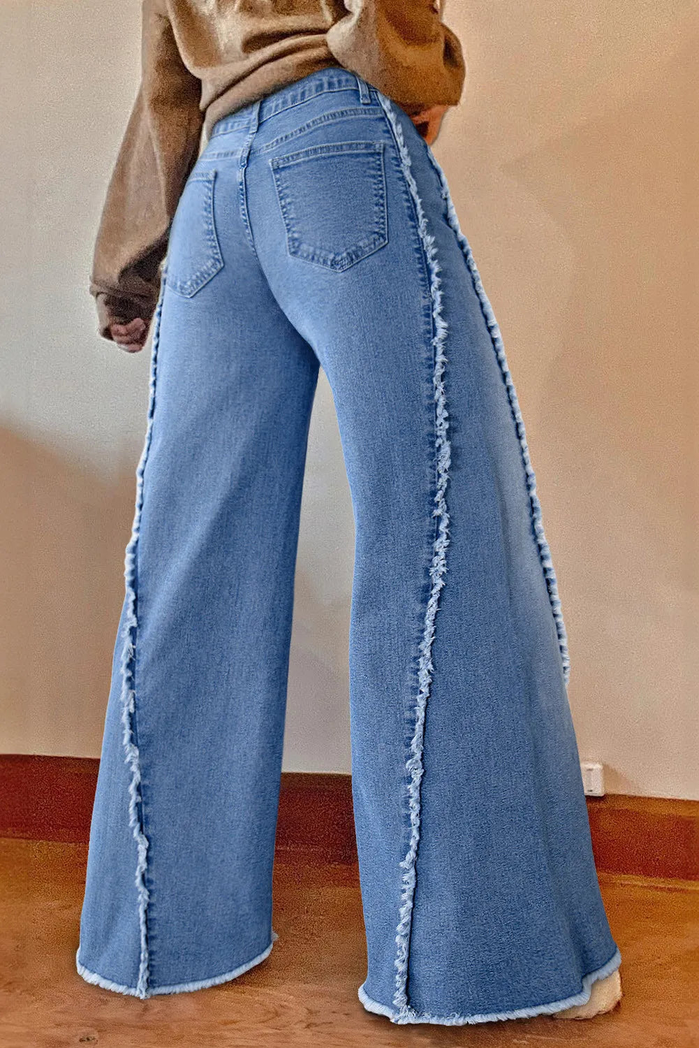 Raw hem wide leg jeans with pockets, back view.