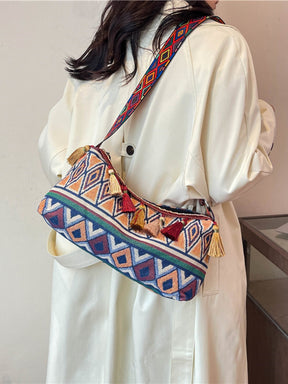 Model wearing boho tassel shoulder bag with geometric design