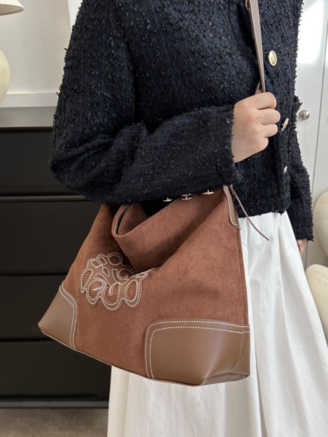 Dark brown suede patch tote bag with adjustable strap.