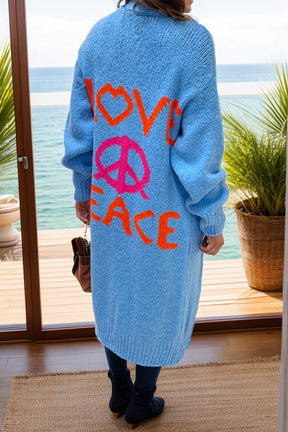 a woman standing in front of a window with a peace sign on it