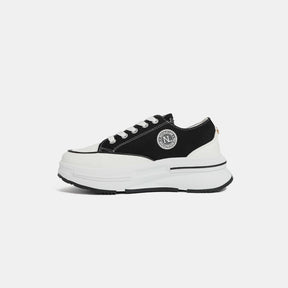 Nicole Lee USA black sneakers with logo detail, side view.