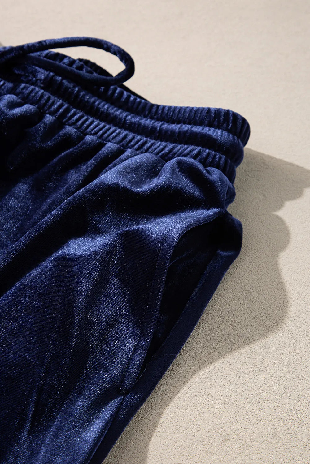 Close-up of navy velvet drawstring pants