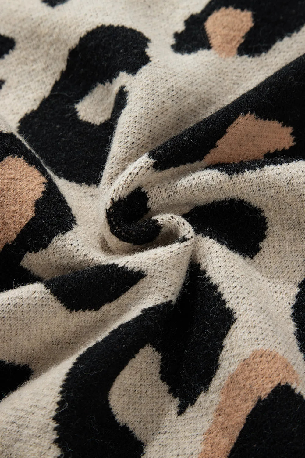 Close-up of leopard print fabric on cardigan