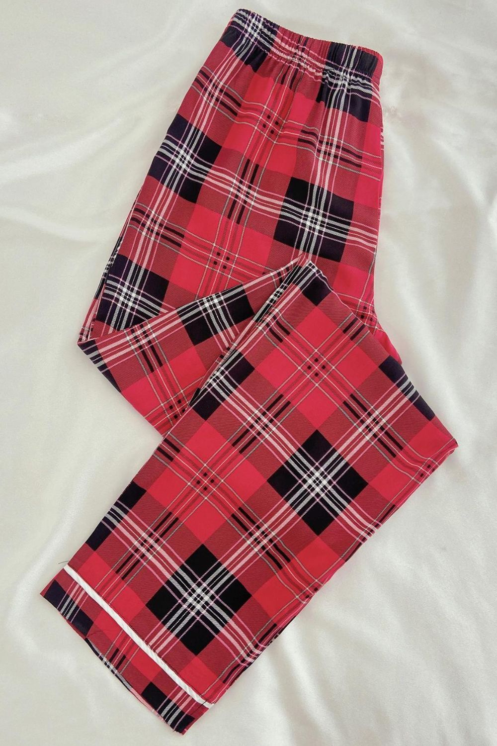 Red plaid loungewear pants on white background