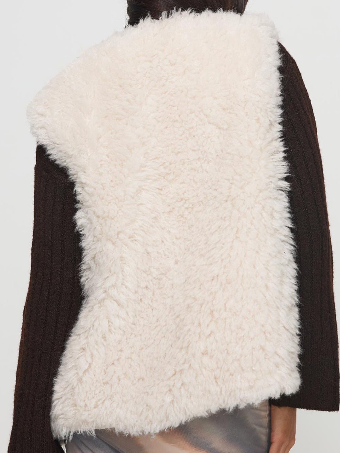 Back view of cream fuzzy open front vest coat