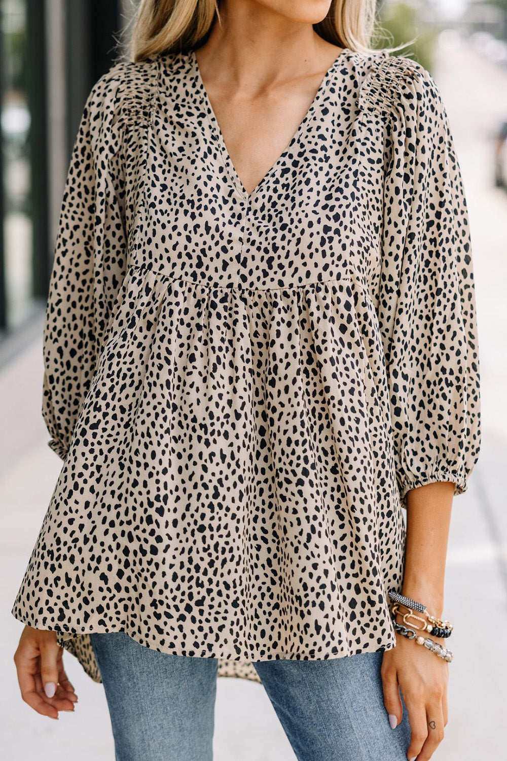 Front view of animal print V-neck blouse, three-quarter sleeves.