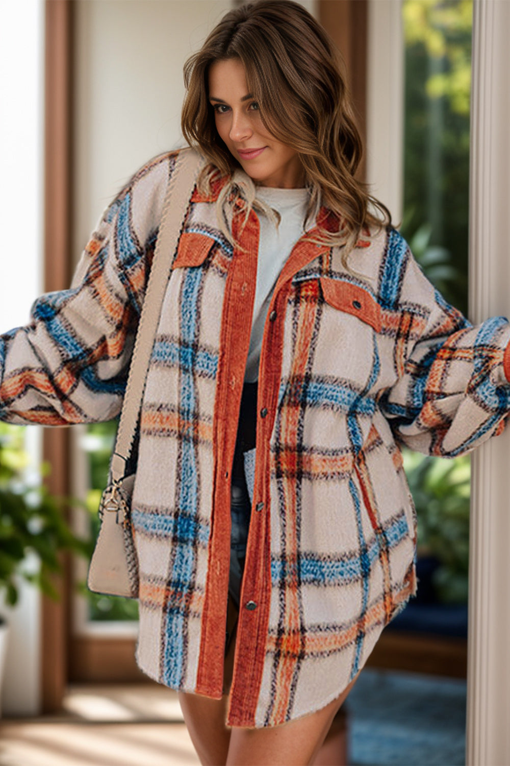 a woman standing in front of a door wearing a plaid jacket