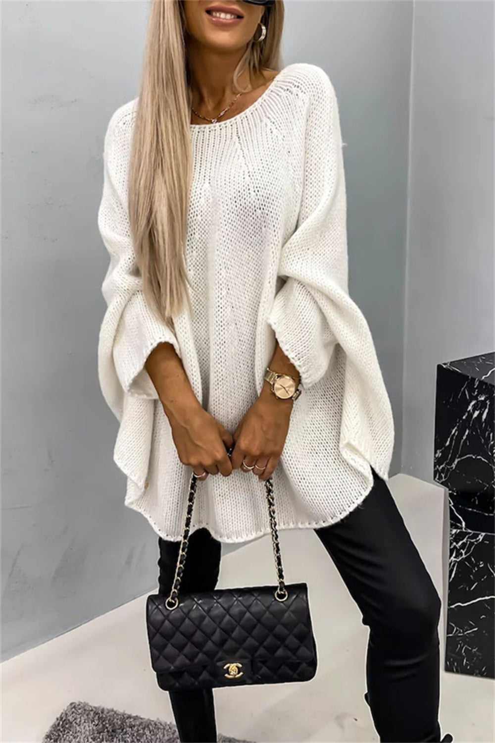 White batwing sleeve sweater with round neck, elegant and cozy.