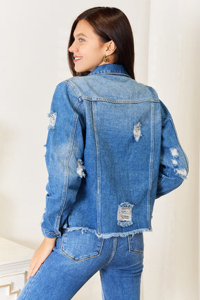 Back view of distressed raw hem denim jacket.