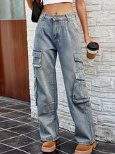 Front view of washed cargo jeans with pockets