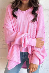 Pink waffle-knit V-neck long sleeve blouse worn by model