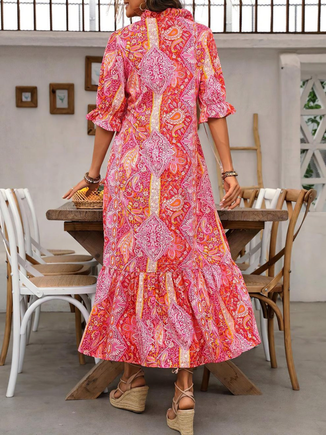 Back view of pink printed tie neck flounce sleeve midi dress