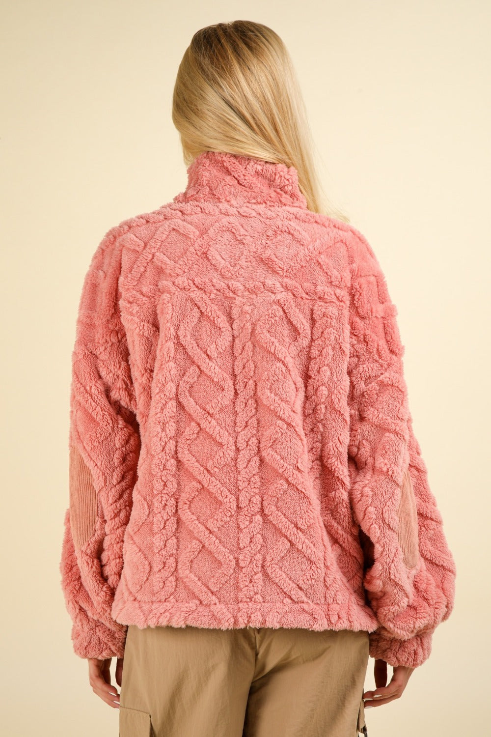 Back view of pink fuzzy fleece sweatshirt with cable pattern