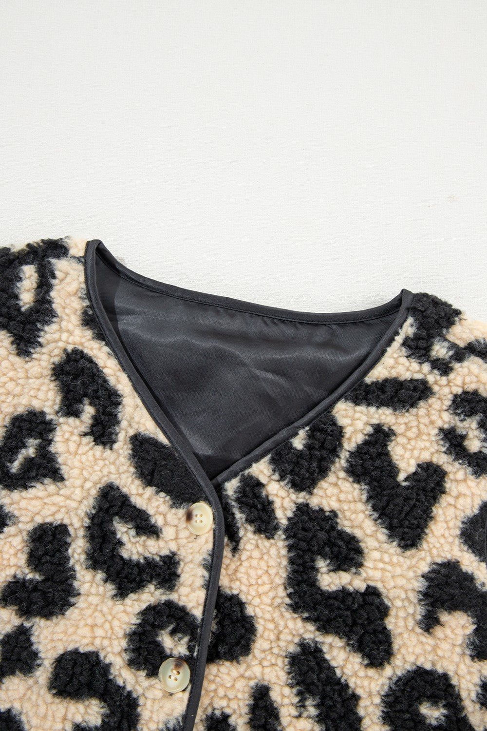 Close-up of leopard button up vest coat fabric