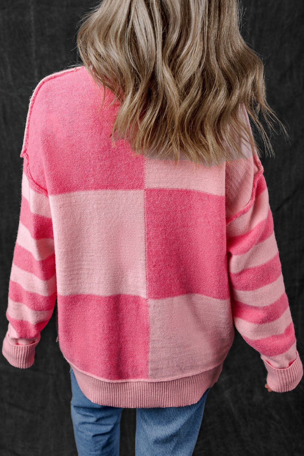 Pink exposed seam round neck sweater, back view