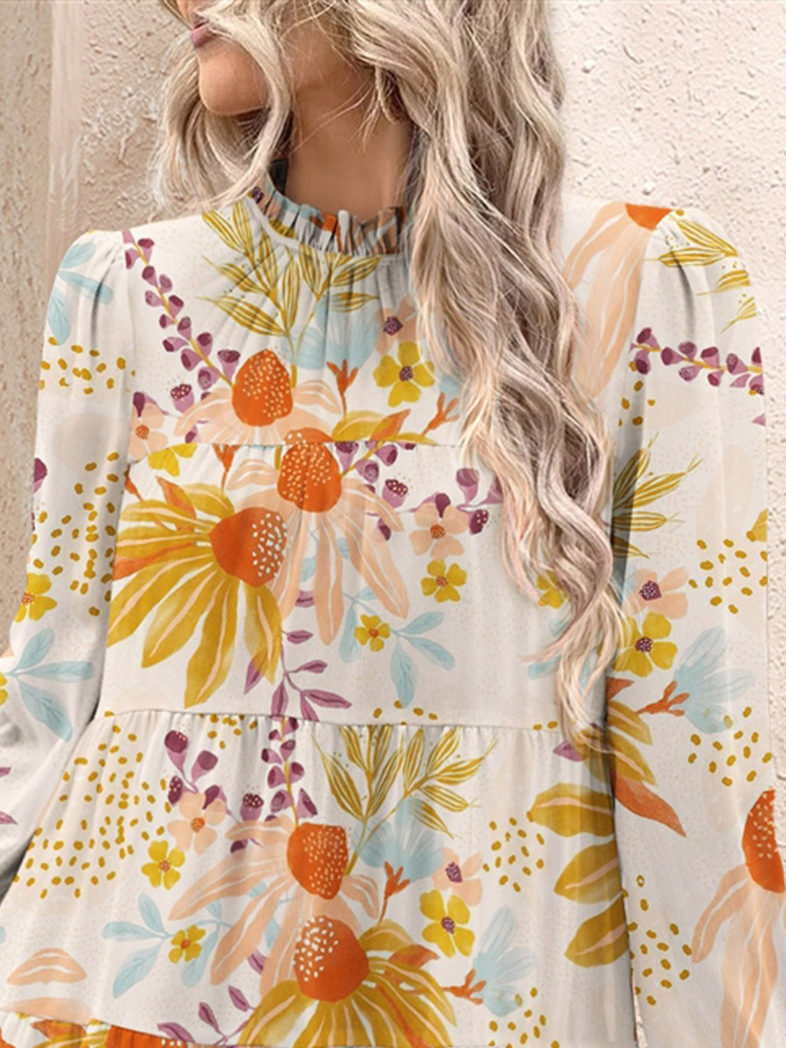 a woman with long hair wearing a floral blouse