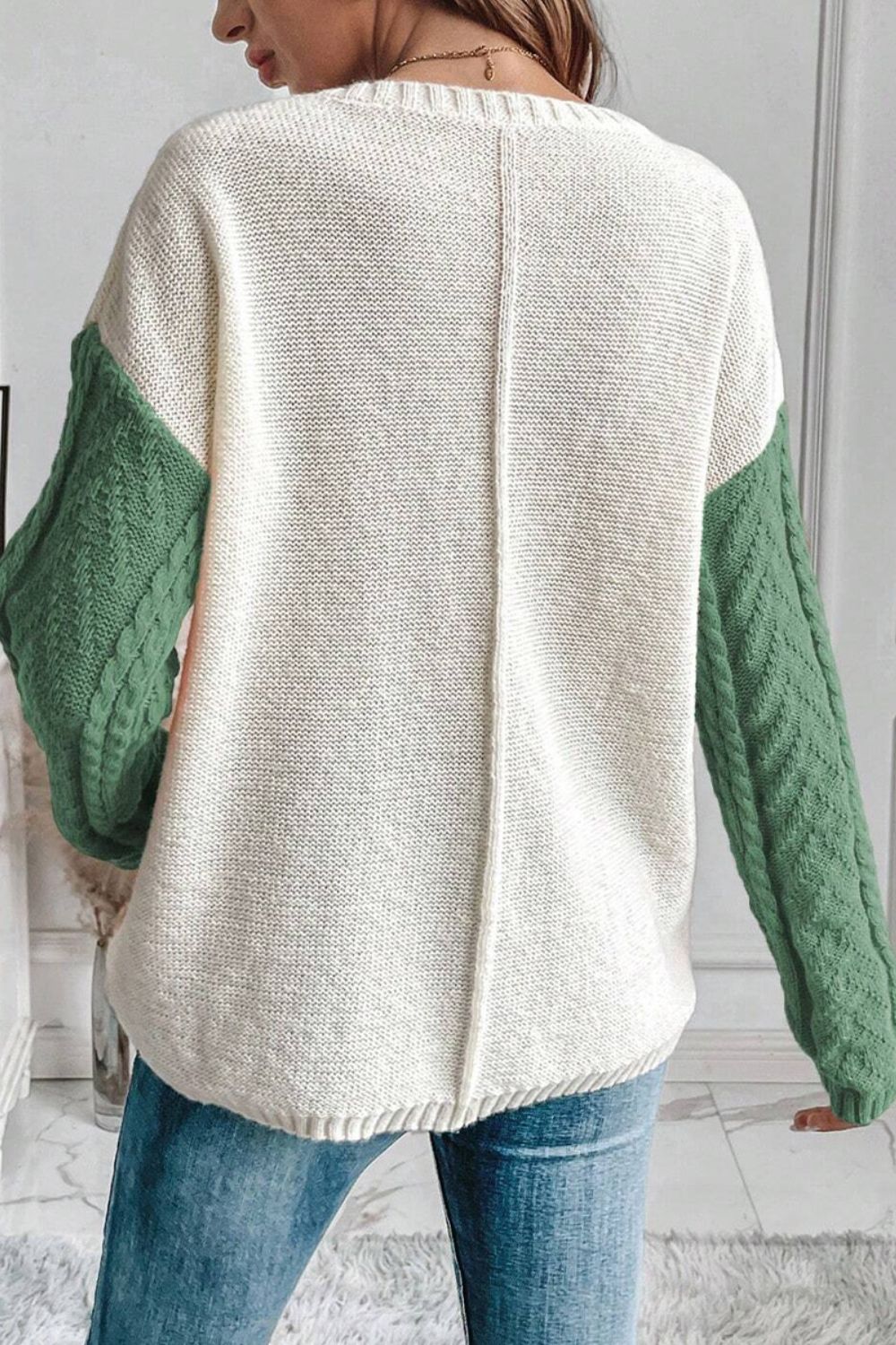 Back view of green and cream color block sweater