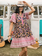 Woman wearing printed V-neck short sleeve mini dress