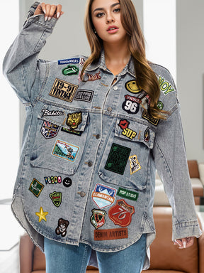 Denim jacket with colorful embroidered patches, front view.